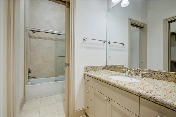 a view of staircase with lots of frames on wall and a window
