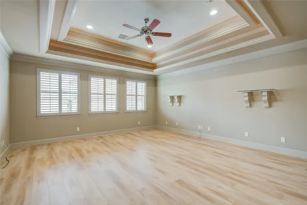 a view of a building with a large window and sitting area