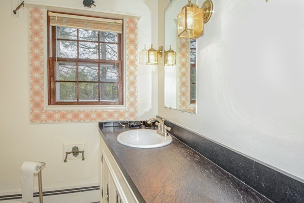 4 Abbott Road Natick, MA 01760 - Photo 20 of 30 a bathroom with a sink and a mirror