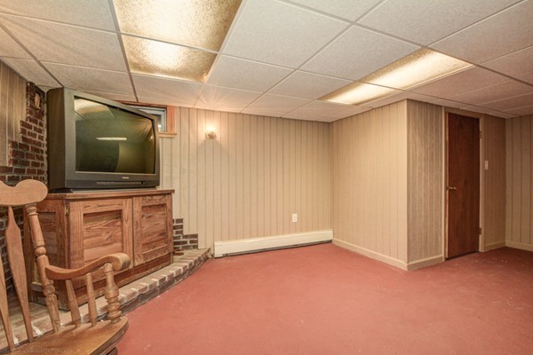 4 Abbott Road Natick, MA 01760 - Photo 23 of 30 a living room with furniture and a flat screen tv