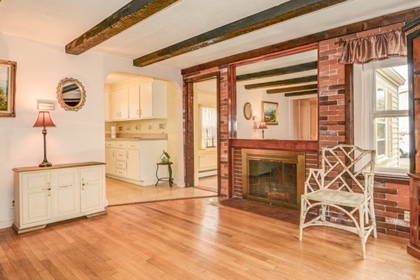 4 Abbott Road Natick, MA 01760 - Photo 5 of 30 a living room with furniture a fireplace and wooden floor