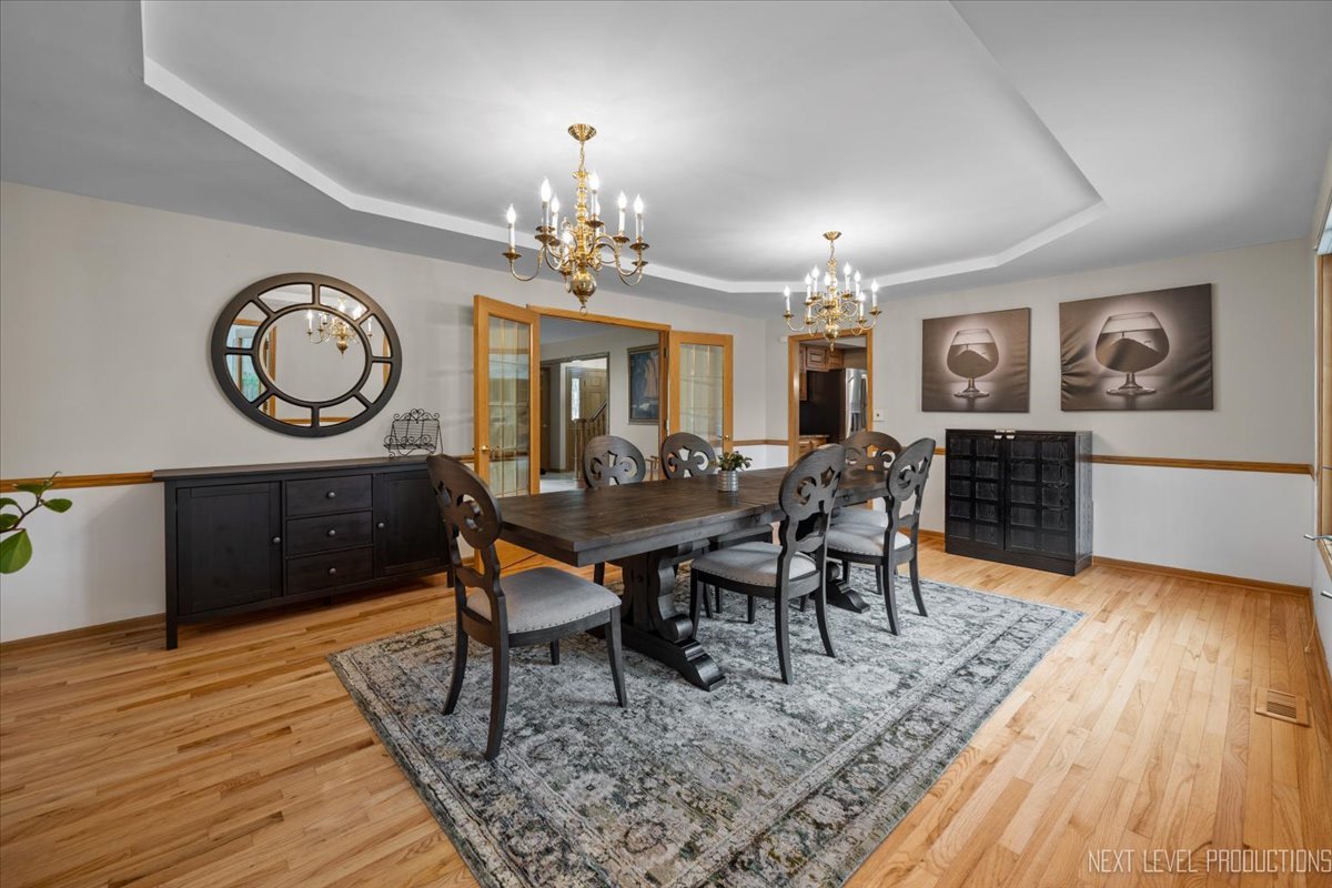 905 Merrill New Road Sugar Grove, IL 60554 - Photo 12 of 44 a view of a dining room with furniture a chandelier and wooden floor