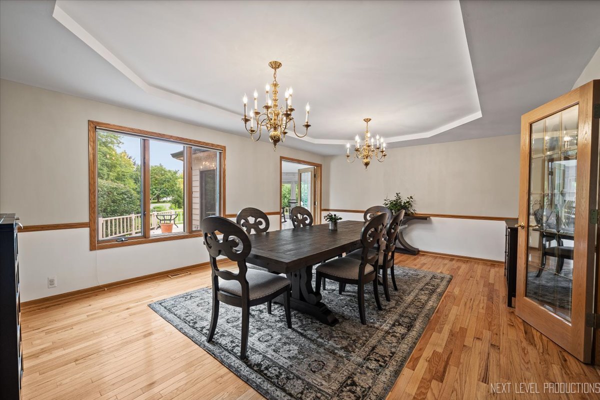 905 Merrill New Road Sugar Grove, IL 60554 - Photo 13 of 44 a view of a dining room with furniture window and wooden floor