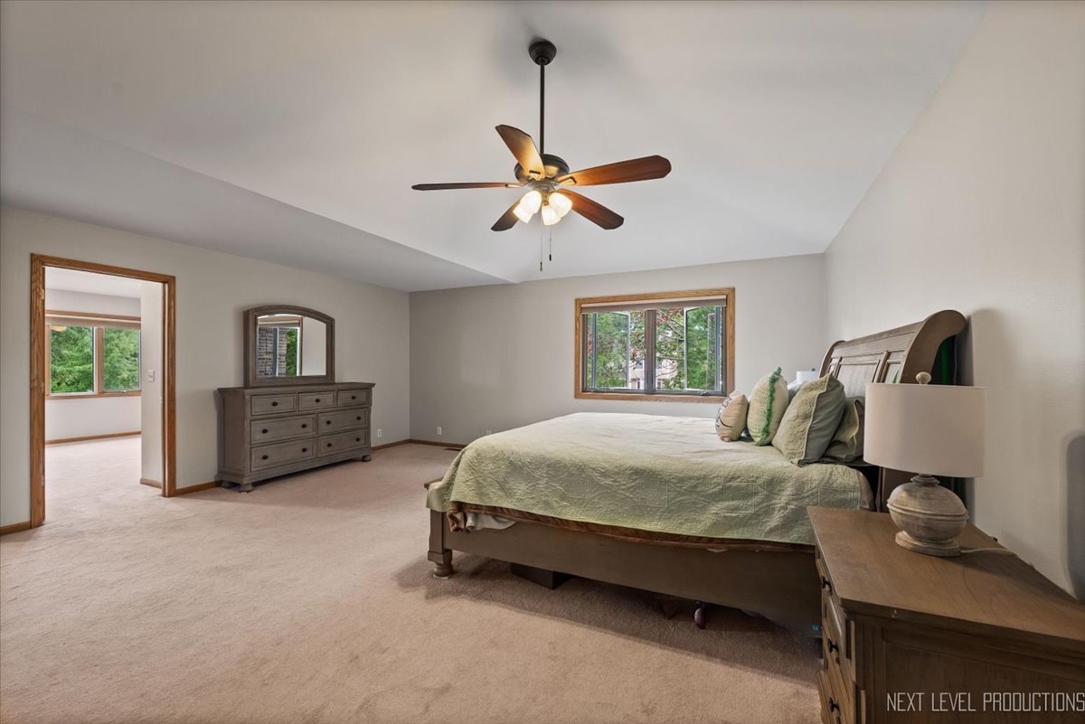 905 Merrill New Road Sugar Grove, IL 60554 - Photo 19 of 44 a bedroom with a bed a couch and a window