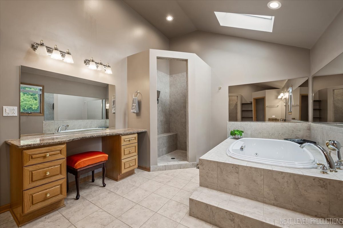 905 Merrill New Road Sugar Grove, IL 60554 - Photo 23 of 44 a spacious bathroom with a tub sink and mirror