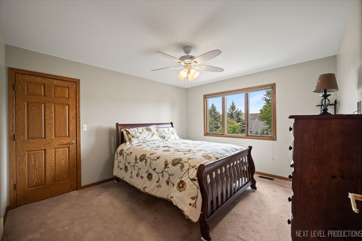 905 Merrill New Road Sugar Grove, IL 60554 - Photo 29 of 44 a bedroom with a bed dresser and a window