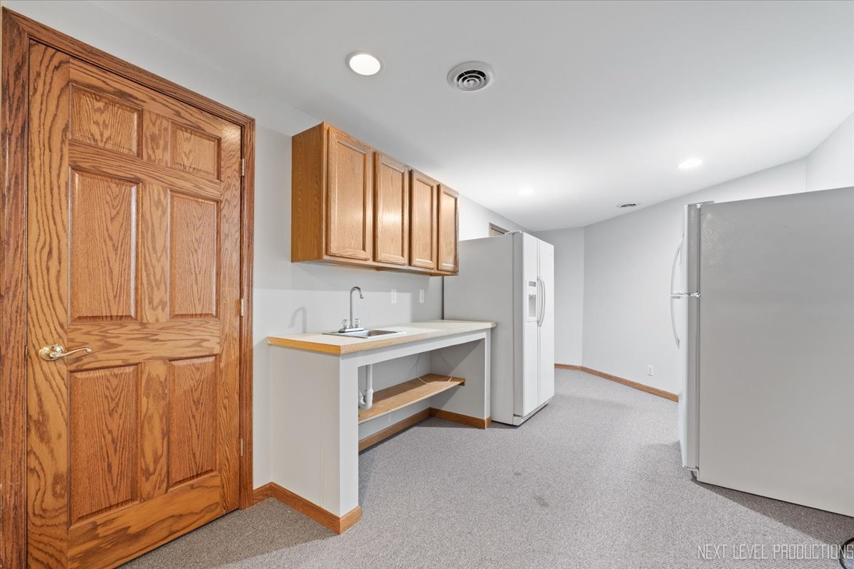 905 Merrill New Road Sugar Grove, IL 60554 - Photo 35 of 44 a bathroom with a sink and a mirror