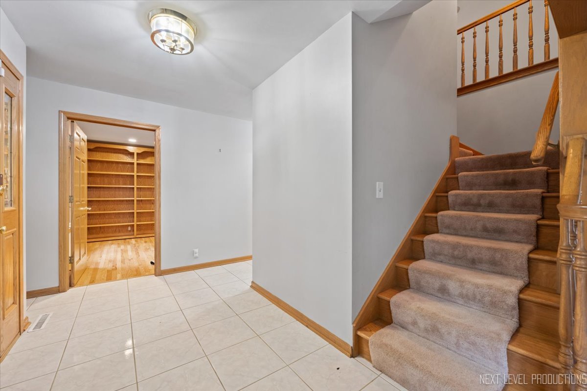 905 Merrill New Road Sugar Grove, IL 60554 - Photo 5 of 44 a view of an entryway with staircase