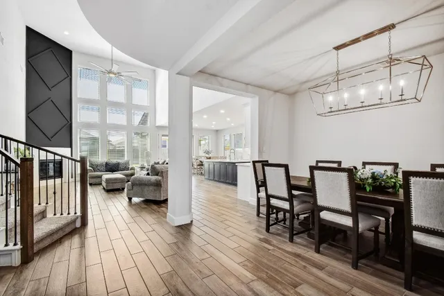a view of a dining room with furniture wooden floor and chandelier