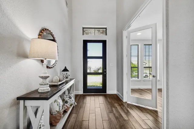 a view of a dining room with furniture a chandelier and wooden floor