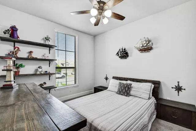a bedroom with bed and window