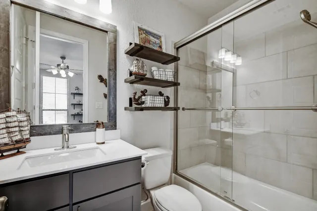 a bathroom with a sink toilet tub and shower