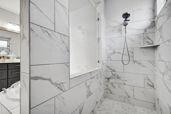 view of a bathroom with a tub and shower