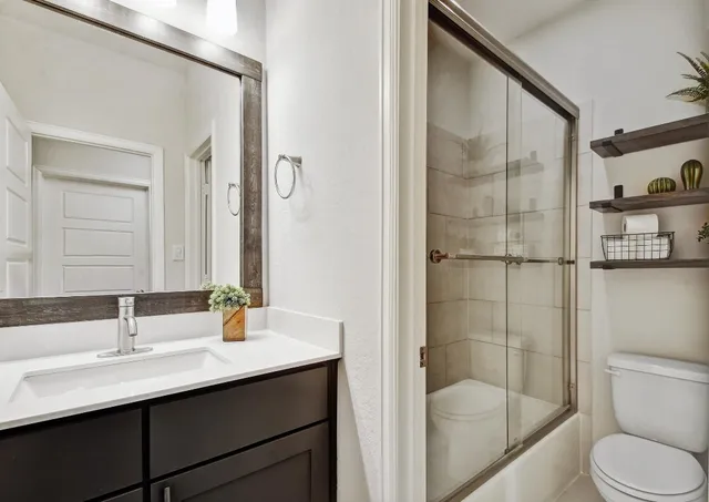 a bathroom with a sink toilet and shower