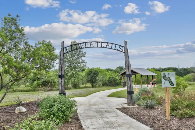 a view of a house with backyard outdoor seating and lake view