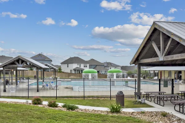 a view of a house with backyard outdoor seating and lake view