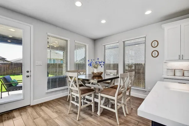 a kitchen with refrigerator cabinets and wooden floor