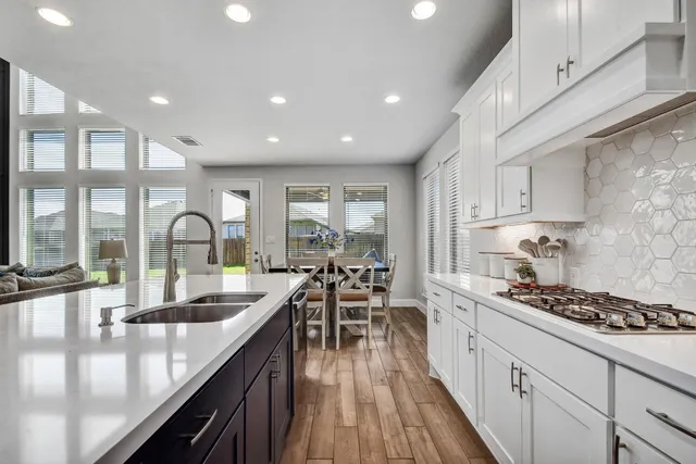 a kitchen with counter top space sink and center island