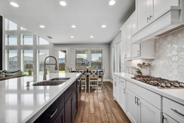 a kitchen with counter top space sink and center island