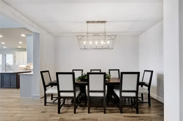 a kitchen with stainless steel appliances a sink a counter top space and living room view