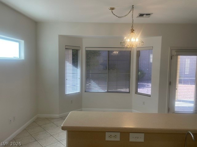3047 Hickory Valley Road Henderson, NV 89052 - Photo 7 of 21 Illuminated dining area with a charming chandelier, perfect for daily meals.