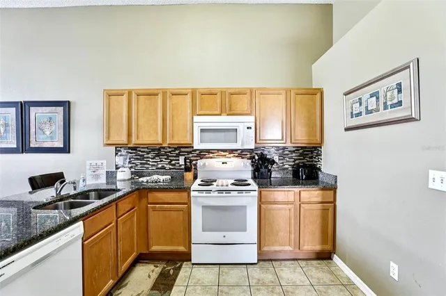 a kitchen with cabinets and refrigerator
