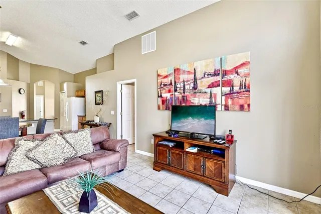 a dining room with wooden floor a chandelier a wooden table and chairs