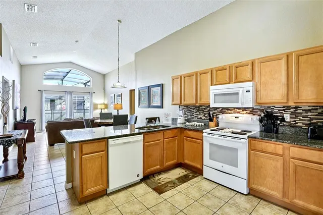 a kitchen with stainless steel appliances granite countertop a sink and cabinets