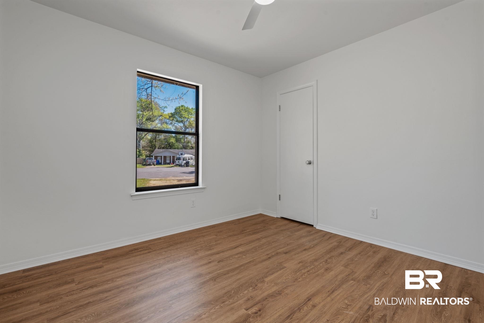 5734 Pheasant Court Theodore, AL 36582 - Photo 13 of 23 Spare room featuring wood finished floors and ceiling fan