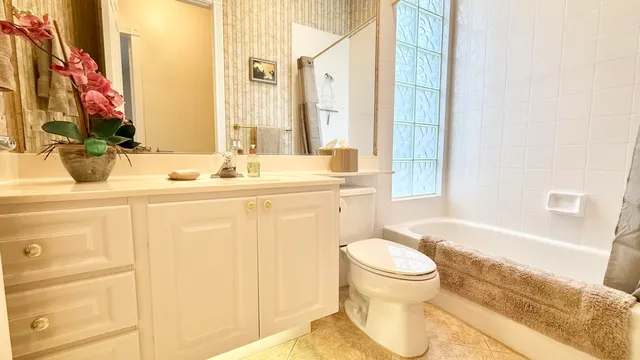 a view of a swimming pool with a table and chairs next to a yard