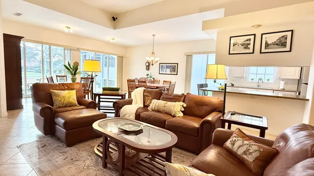 a large white kitchen with wooden floor