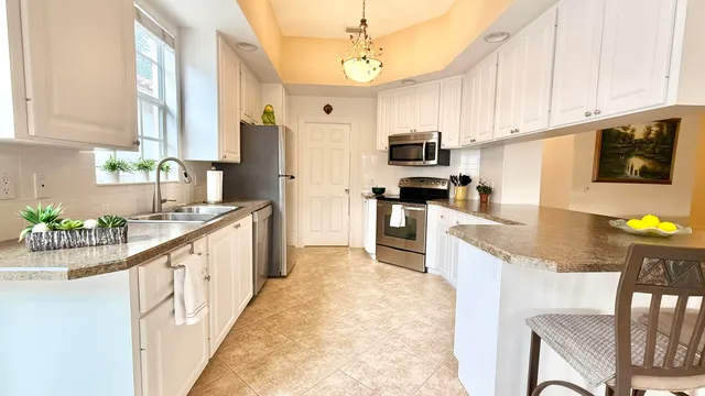 a view of a dining room with furniture and a large window