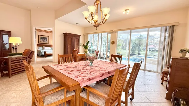 a living room with furniture a table and a large window