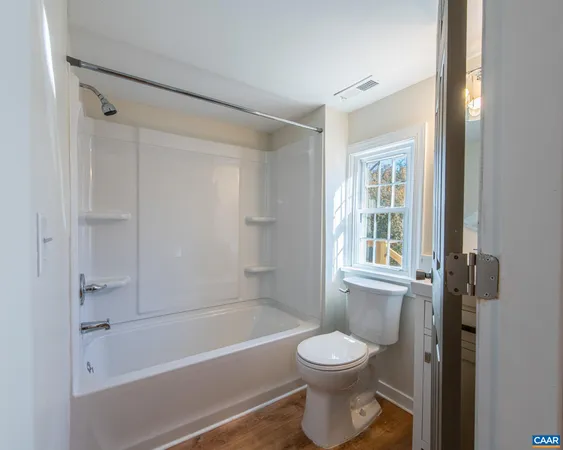 a bathroom with a toilet and a bathtub