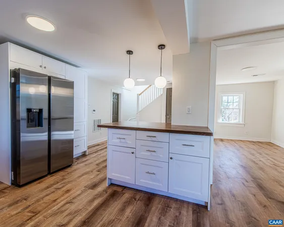 a view of a kitchen counter space and wooden floor