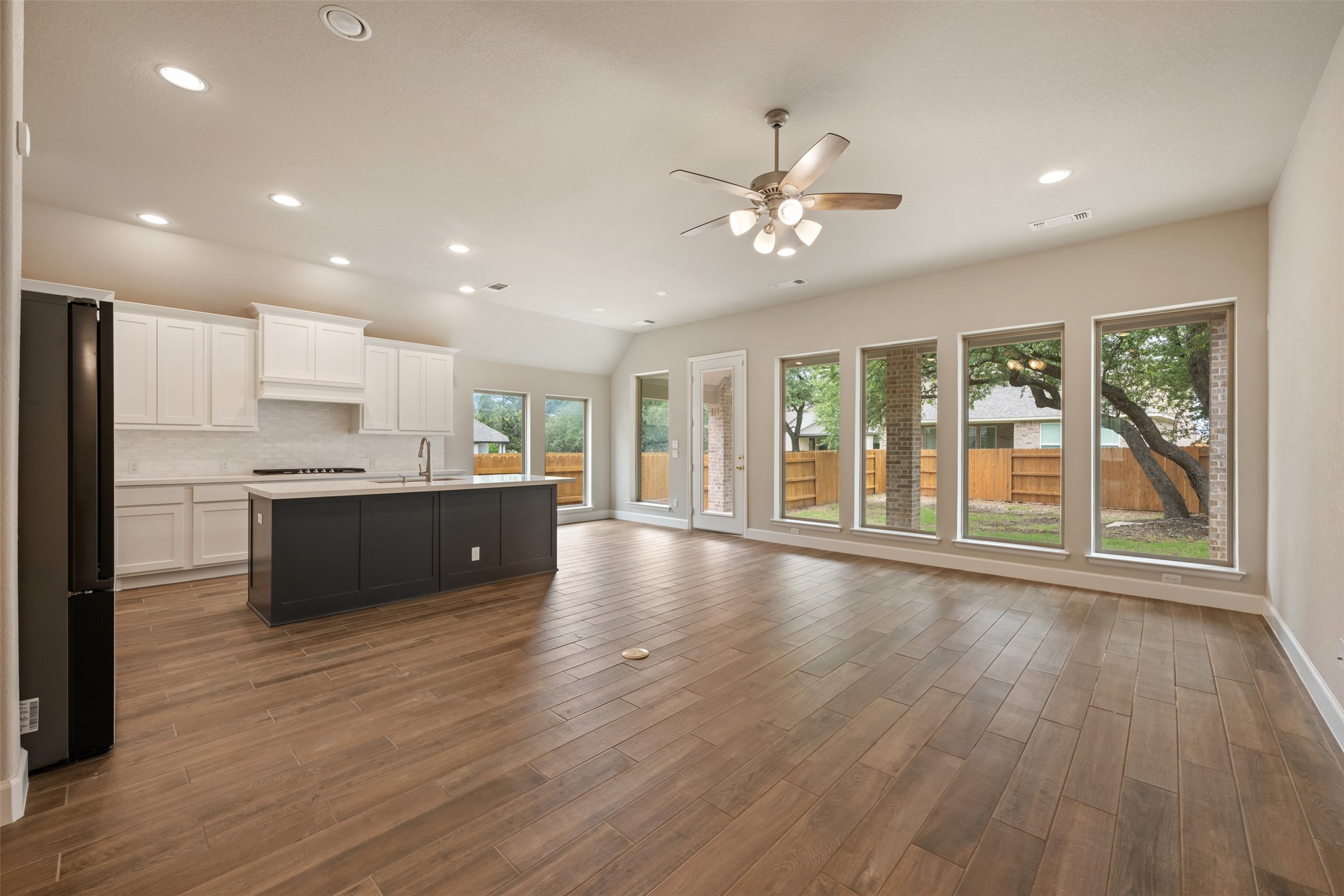104 Anejo Bluff Georgetown, TX 78628 - Photo 20 of 40 a view of large kitchen with a sink wooden floor and a window
