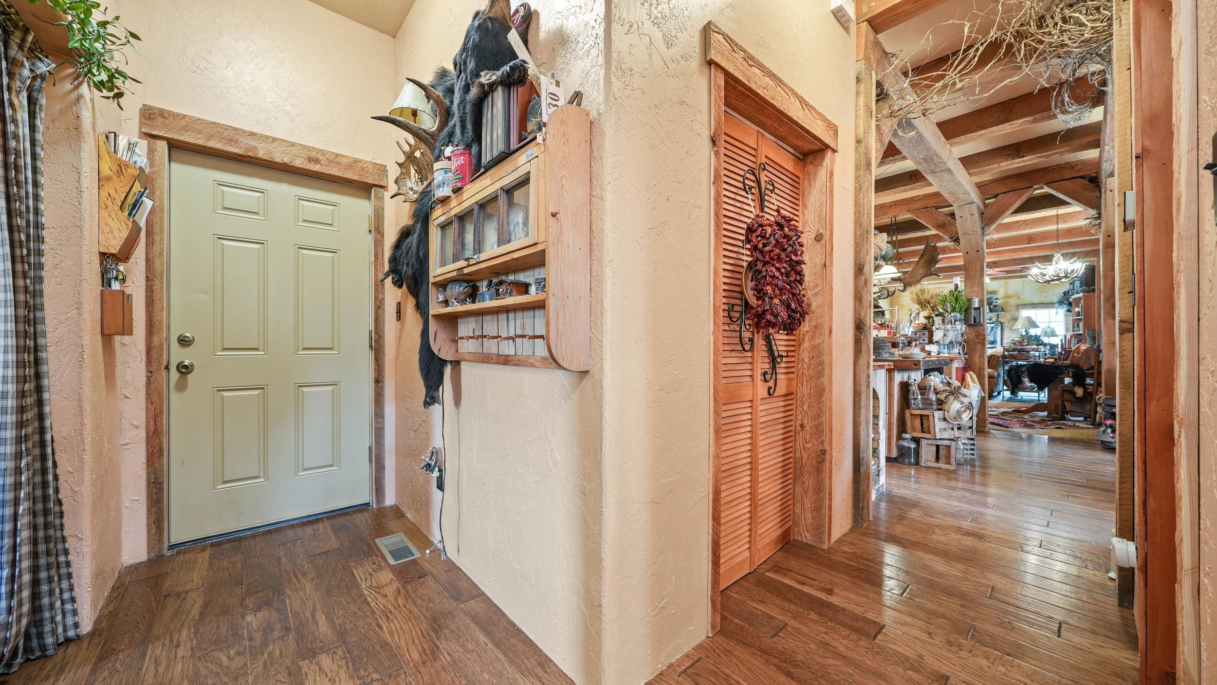 3989 Rapid Creek Road Palisade, CO 81526 - Photo 24 of 39 a view of a hallway with wooden floor and living room