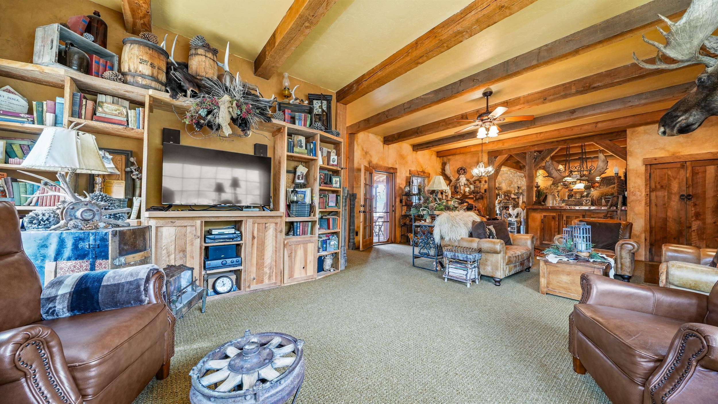 3989 Rapid Creek Road Palisade, CO 81526 - Photo 8 of 39 a living room with furniture and a book shelf