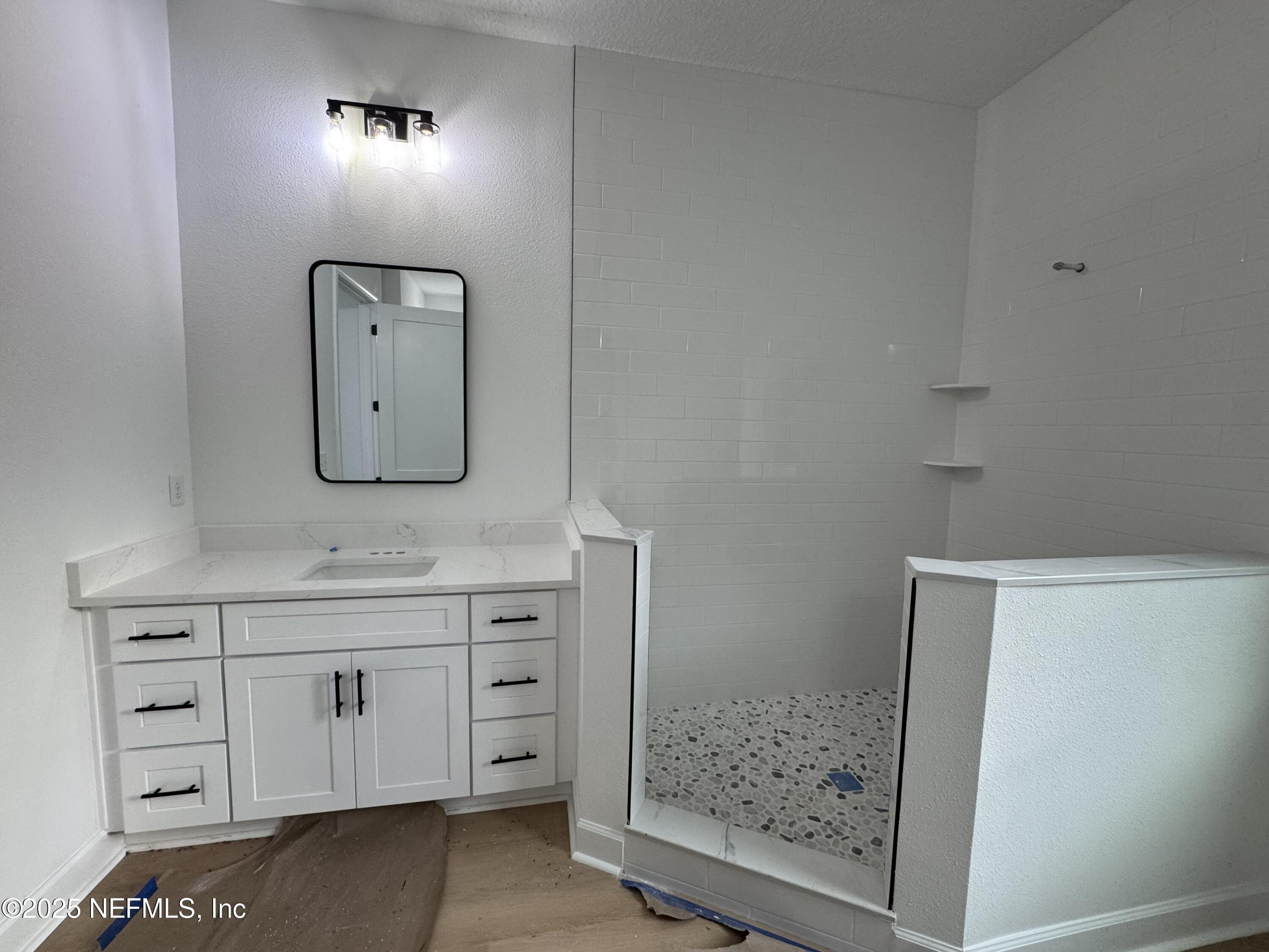 14167 Saddle Ridge Road Macclenny, FL 32063 - Photo 10 of 20 a bathroom with a sink a light fixture and a mirror