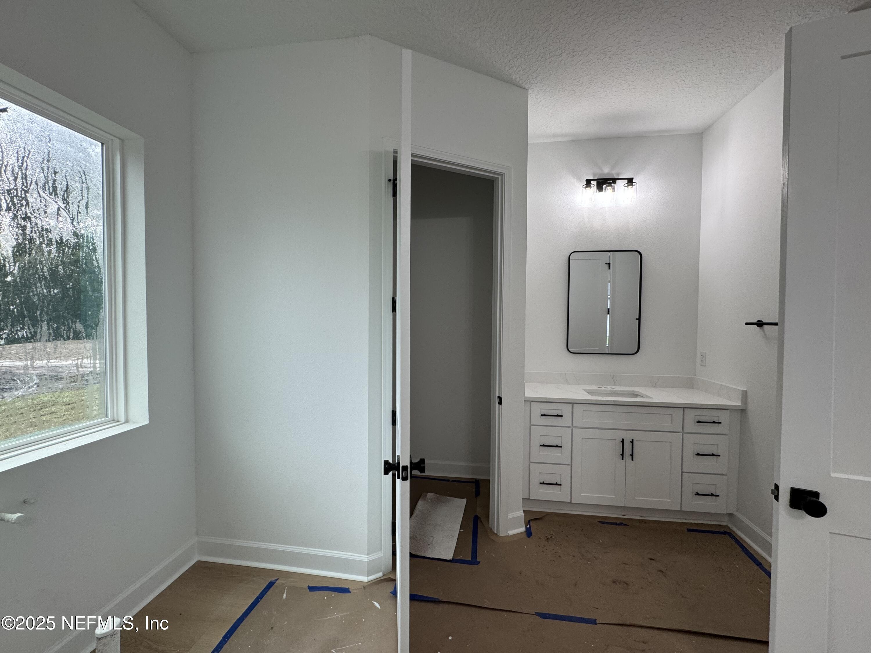 14167 Saddle Ridge Road Macclenny, FL 32063 - Photo 12 of 20 a view of cabinets a sink and a window