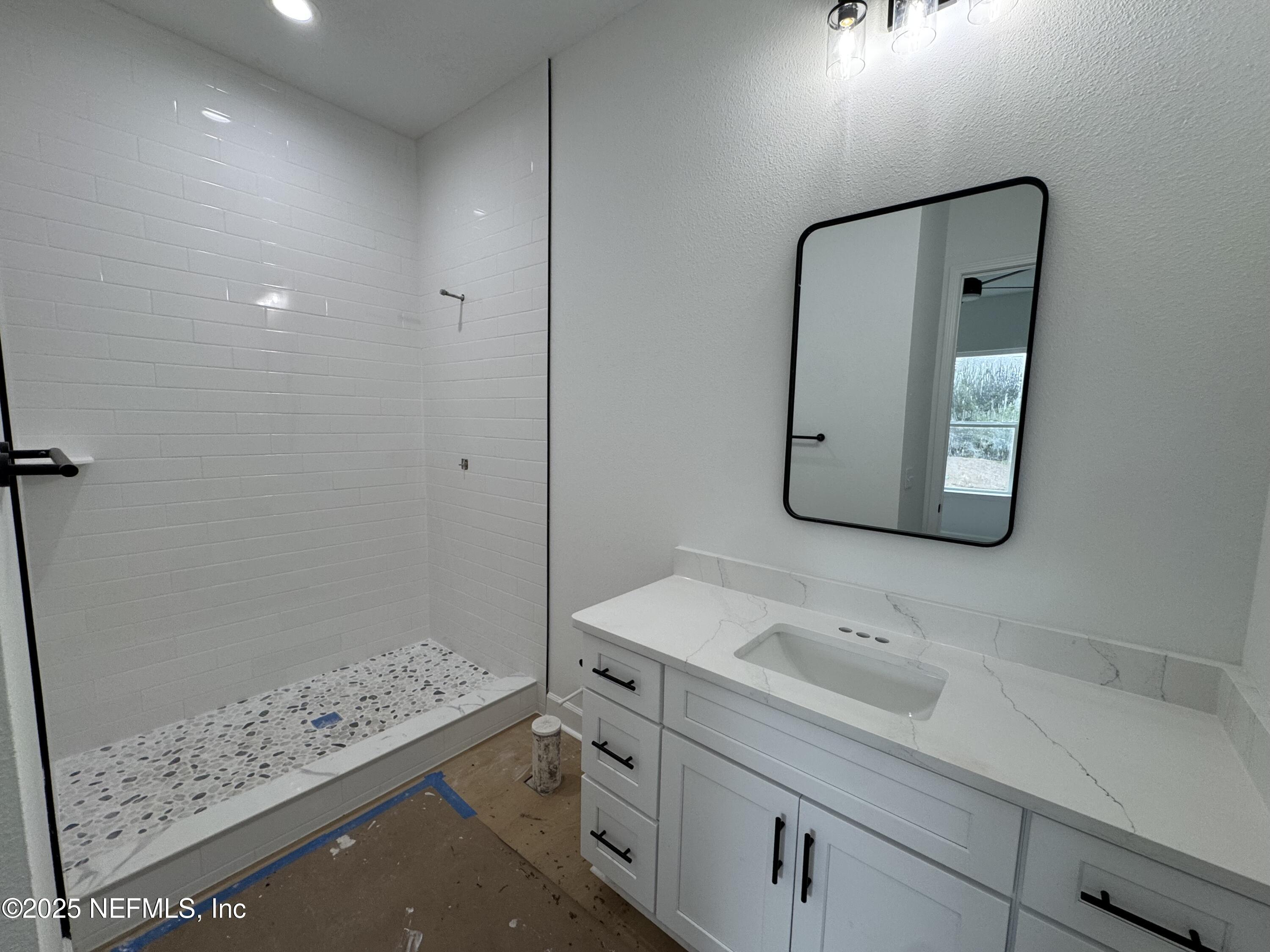 14167 Saddle Ridge Road Macclenny, FL 32063 - Photo 14 of 20 a bathroom with a sink a toilet and shower