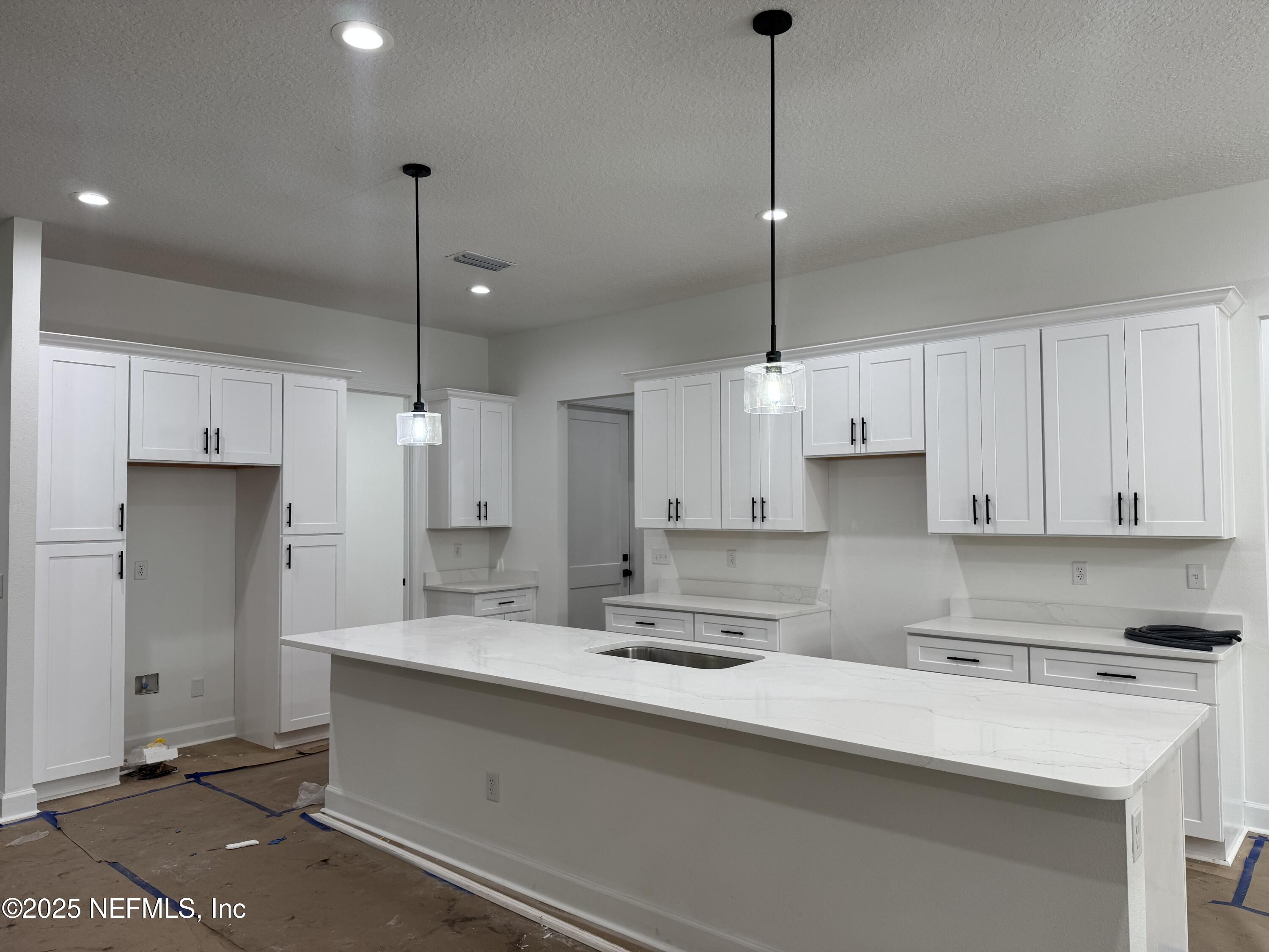 14167 Saddle Ridge Road Macclenny, FL 32063 - Photo 2 of 20 a kitchen with stainless steel appliances sink stove and cabinets