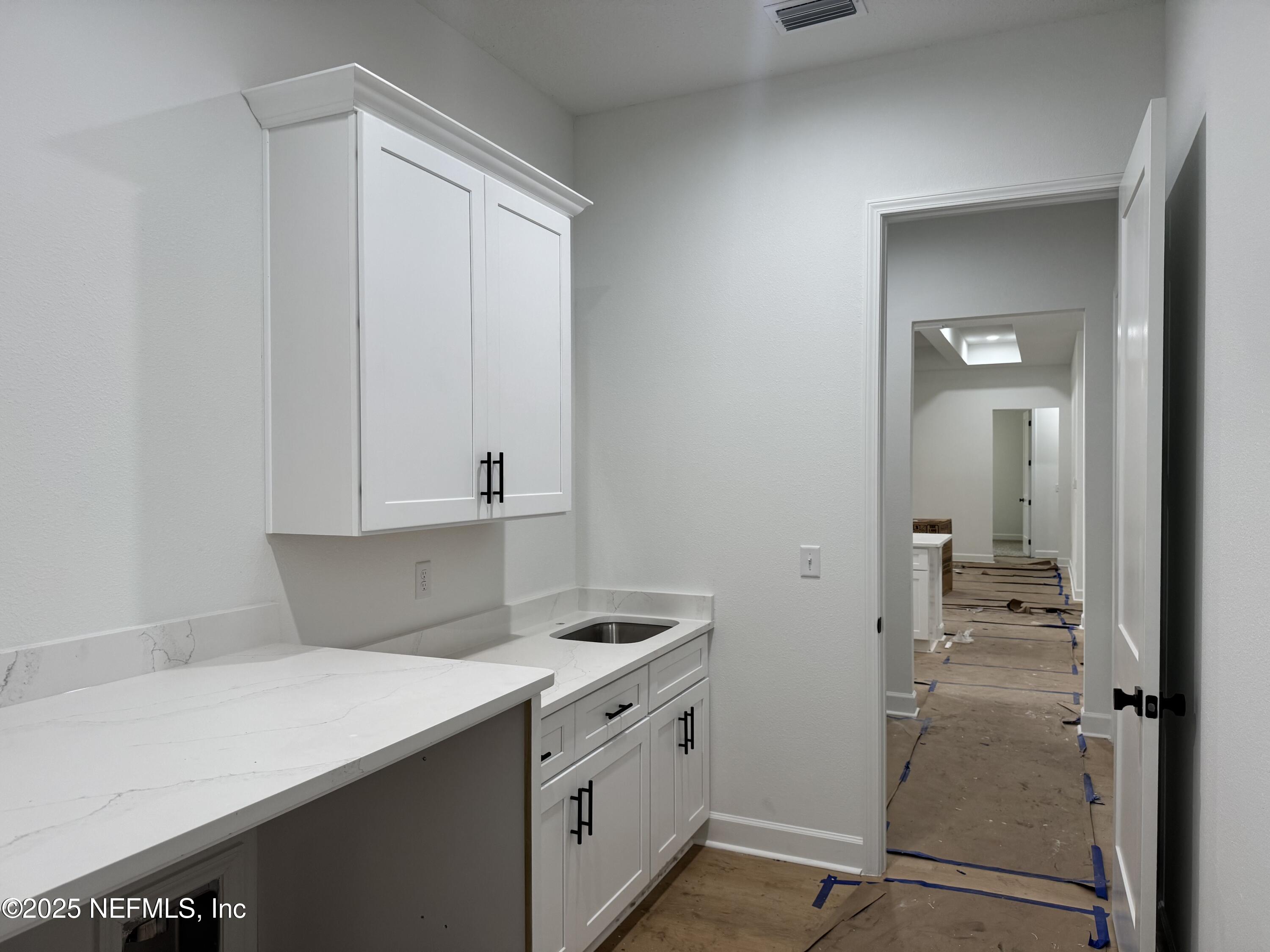 14167 Saddle Ridge Road Macclenny, FL 32063 - Photo 6 of 20 a kitchen with a sink and cabinets