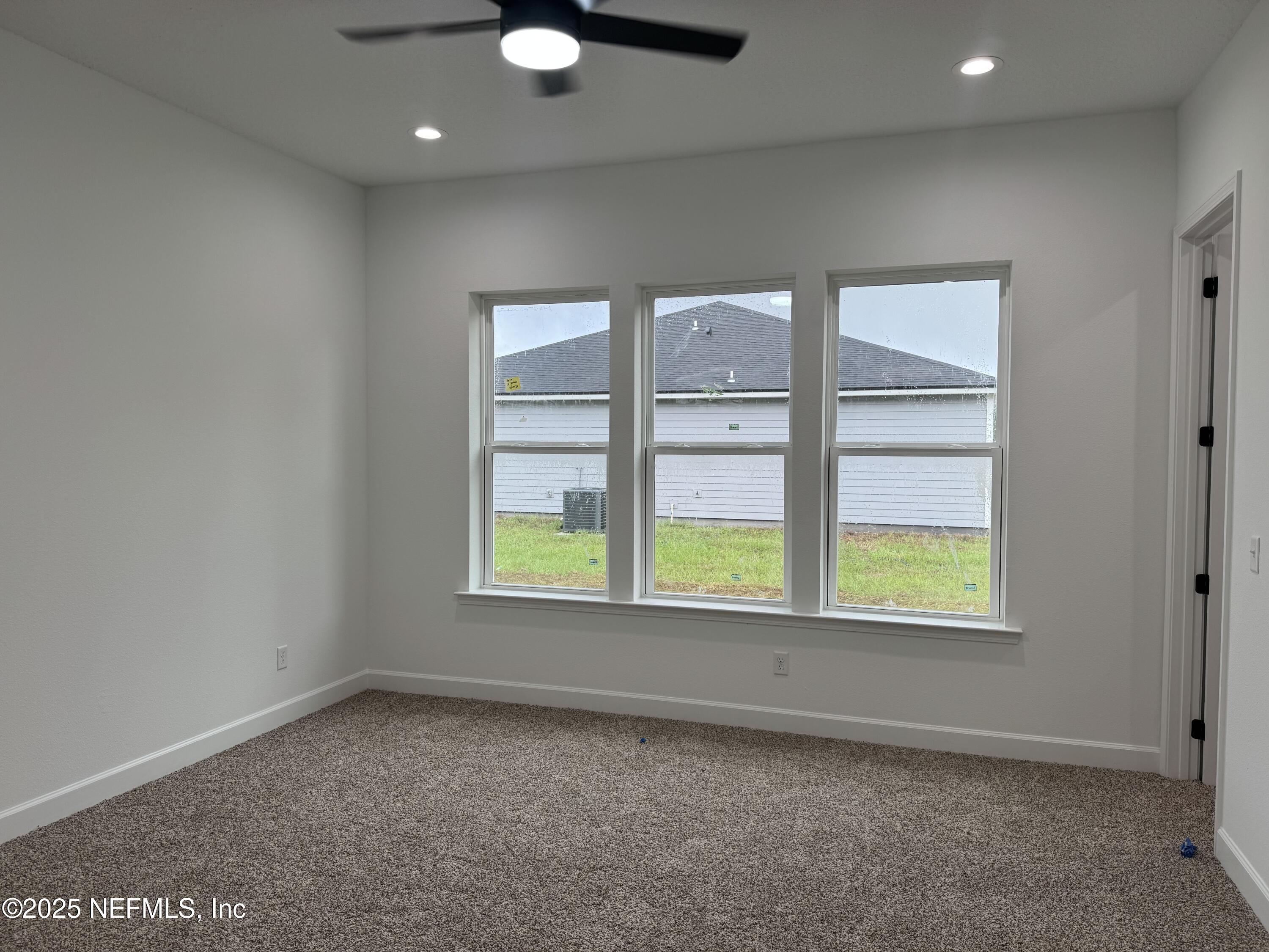 14167 Saddle Ridge Road Macclenny, FL 32063 - Photo 9 of 20 an empty room with windows
