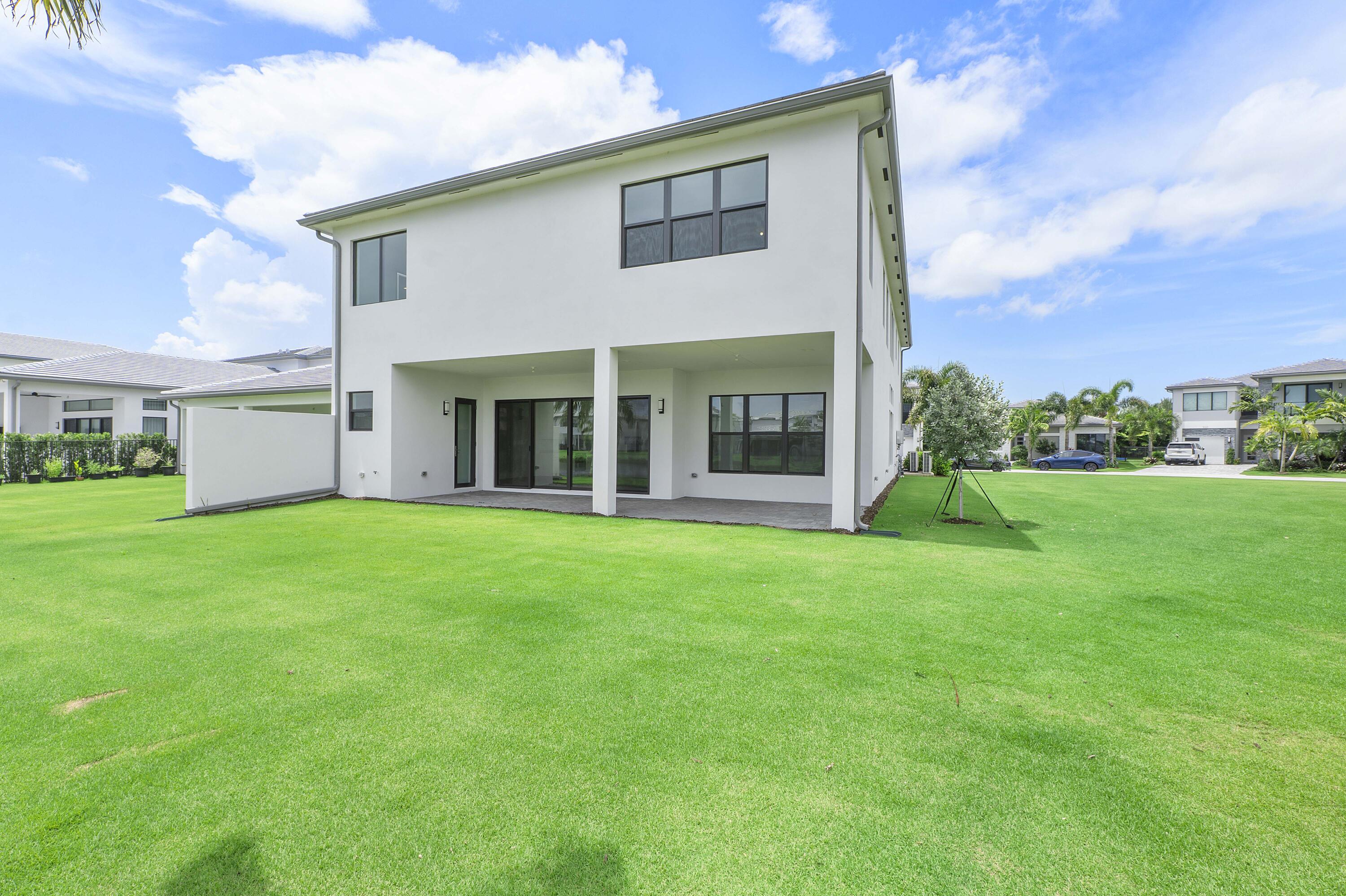 9322 Sunflower Mdw Road Boca Raton, FL 33434 - Photo 58 of 87 a view of a house with backyard porch and garden