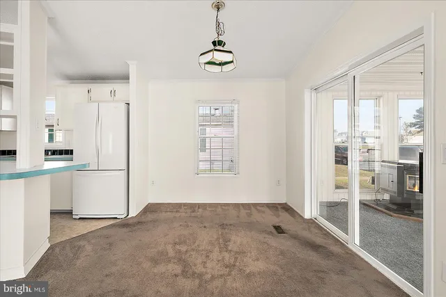 a view of kitchen with stainless steel appliances granite countertop a refrigerator and cabinets