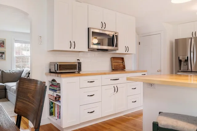 a kitchen with stainless steel appliances a stove microwave and sink