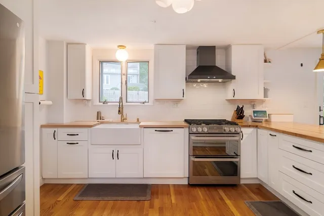 a kitchen with stainless steel appliances a stove a sink and a microwave