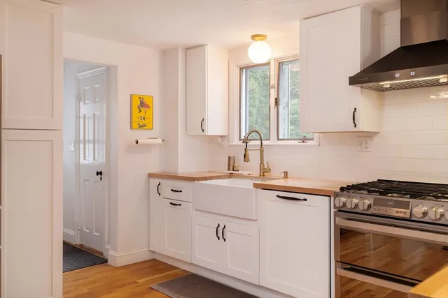 a kitchen with a sink stove and cabinets