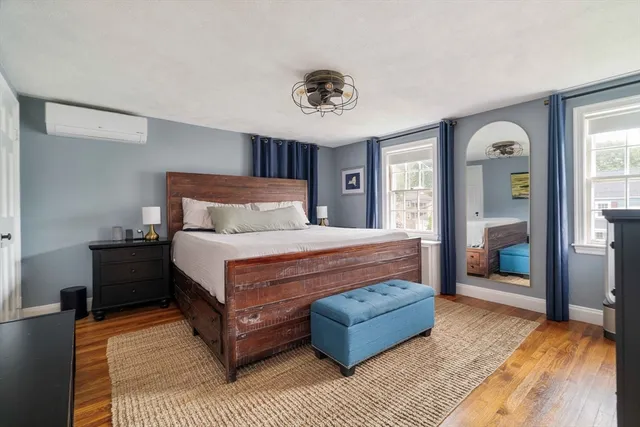 a bedroom with a large bed a chandelier and closet